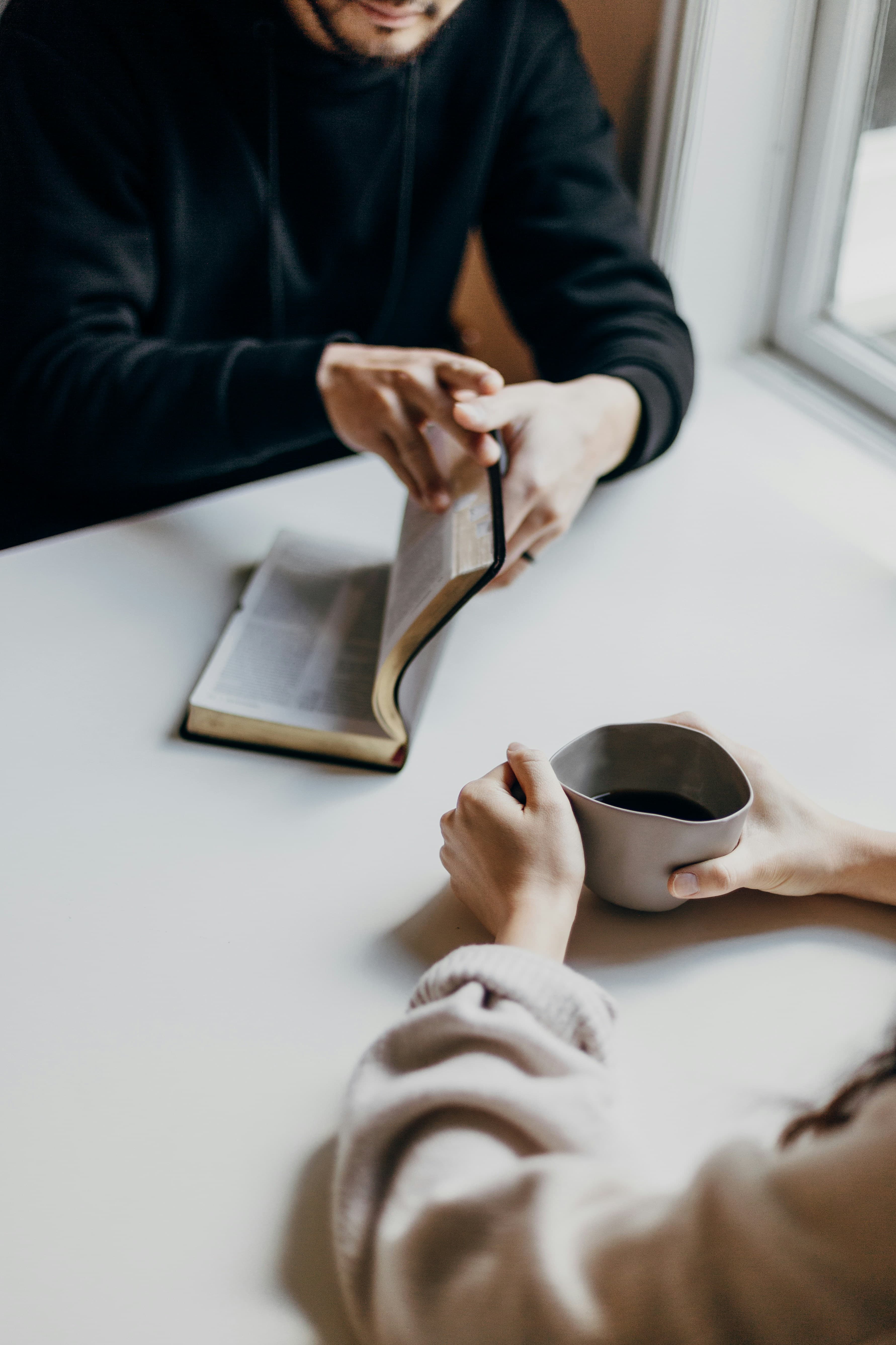 Two people studying the Bible together in community